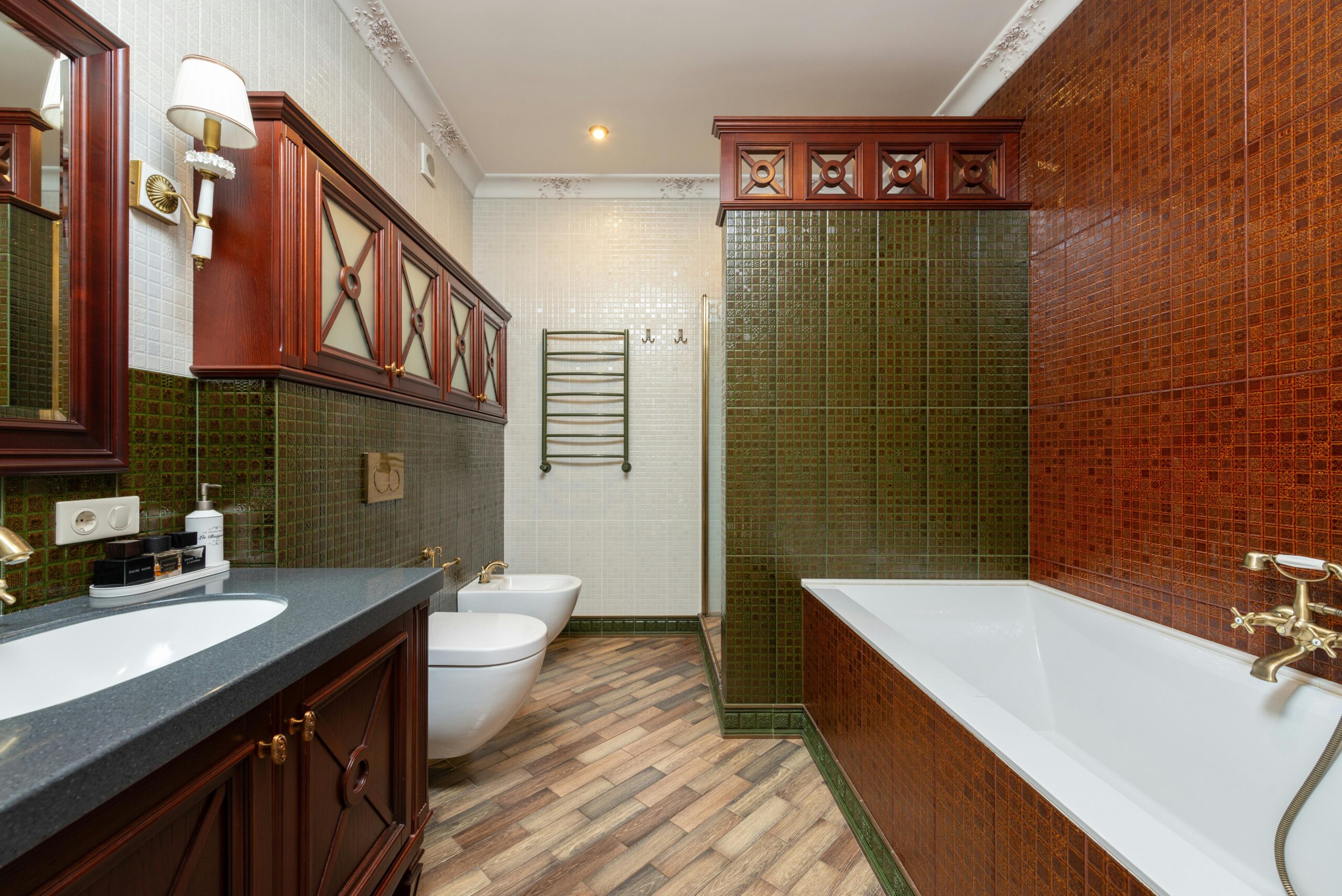 Classic white clawfoot bathtub surrounded by aged tile flooring in a retro-style bathroom.