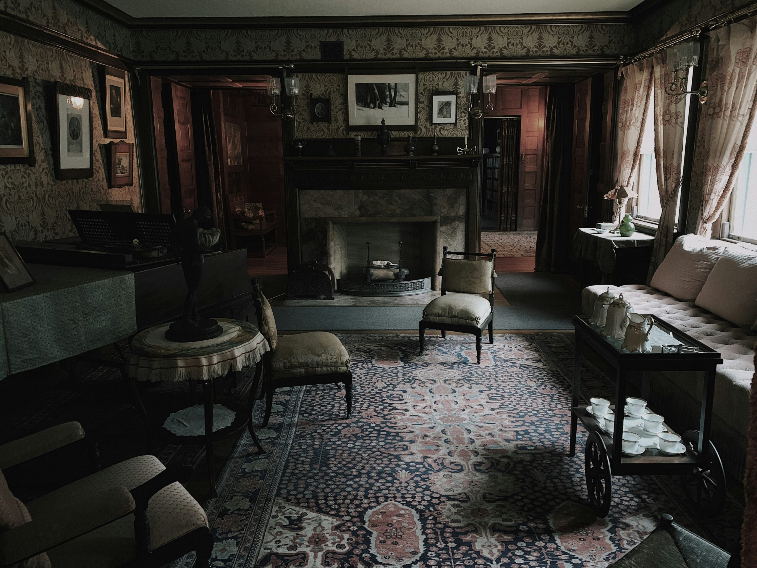 A bedroom decorated with Victorian-era furniture, including a canopy bed and ornate dresser.