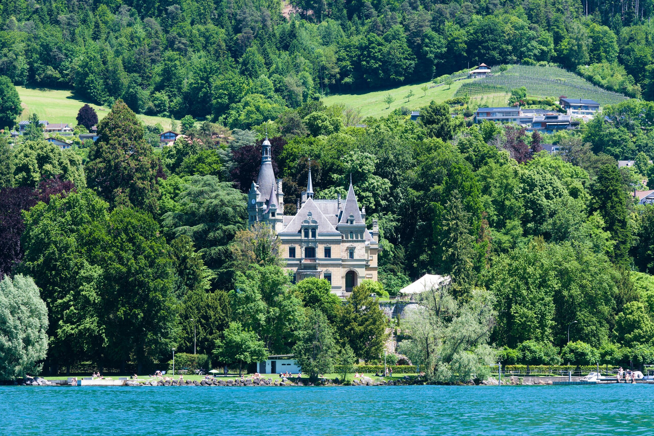 A breathtaking view of a restored medieval castle serving as a vacation home, complete with turrets and lush gardens