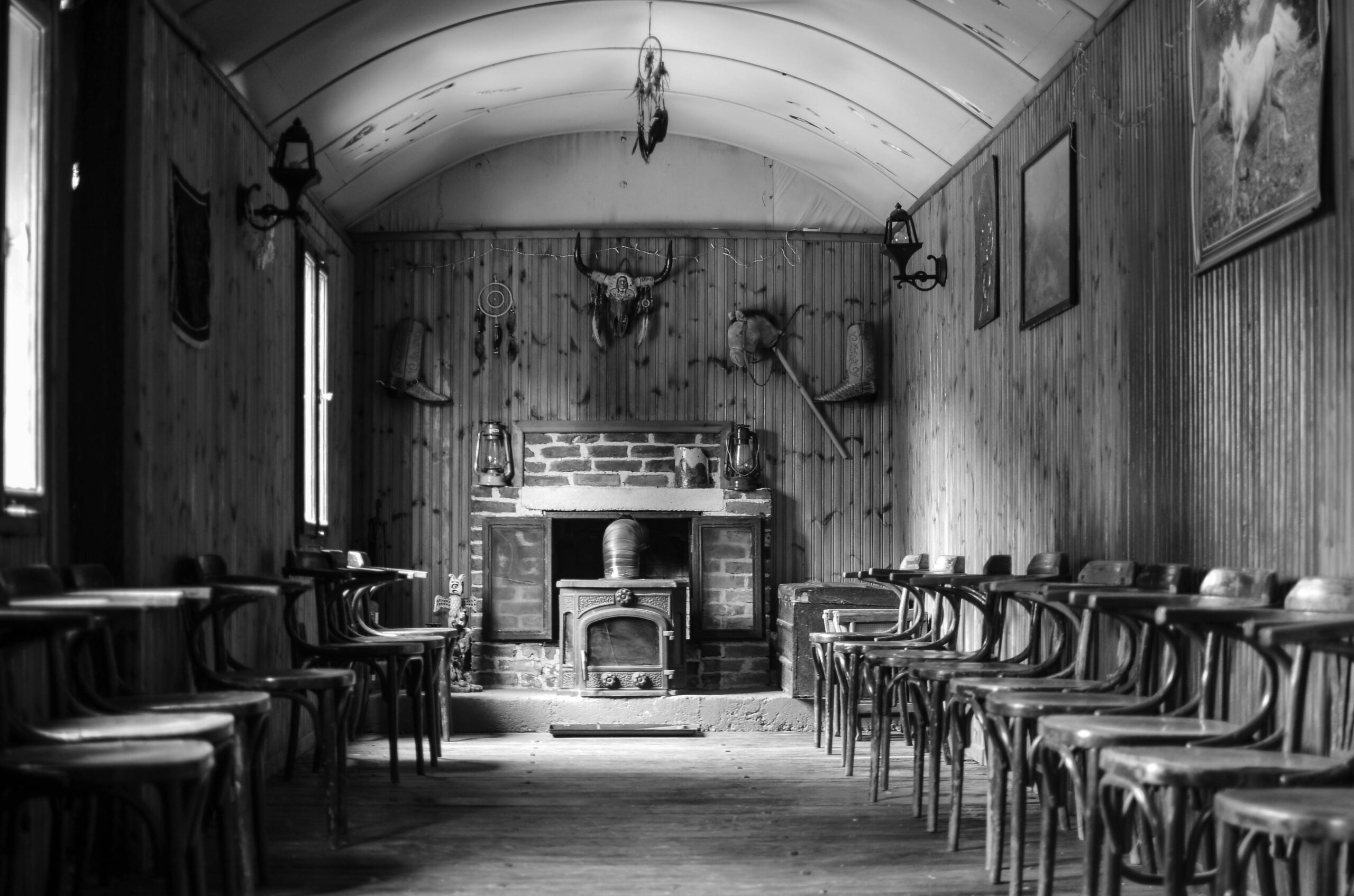 Cozy interior of a historic vacation rental with antique decor and a roaring fireplace
