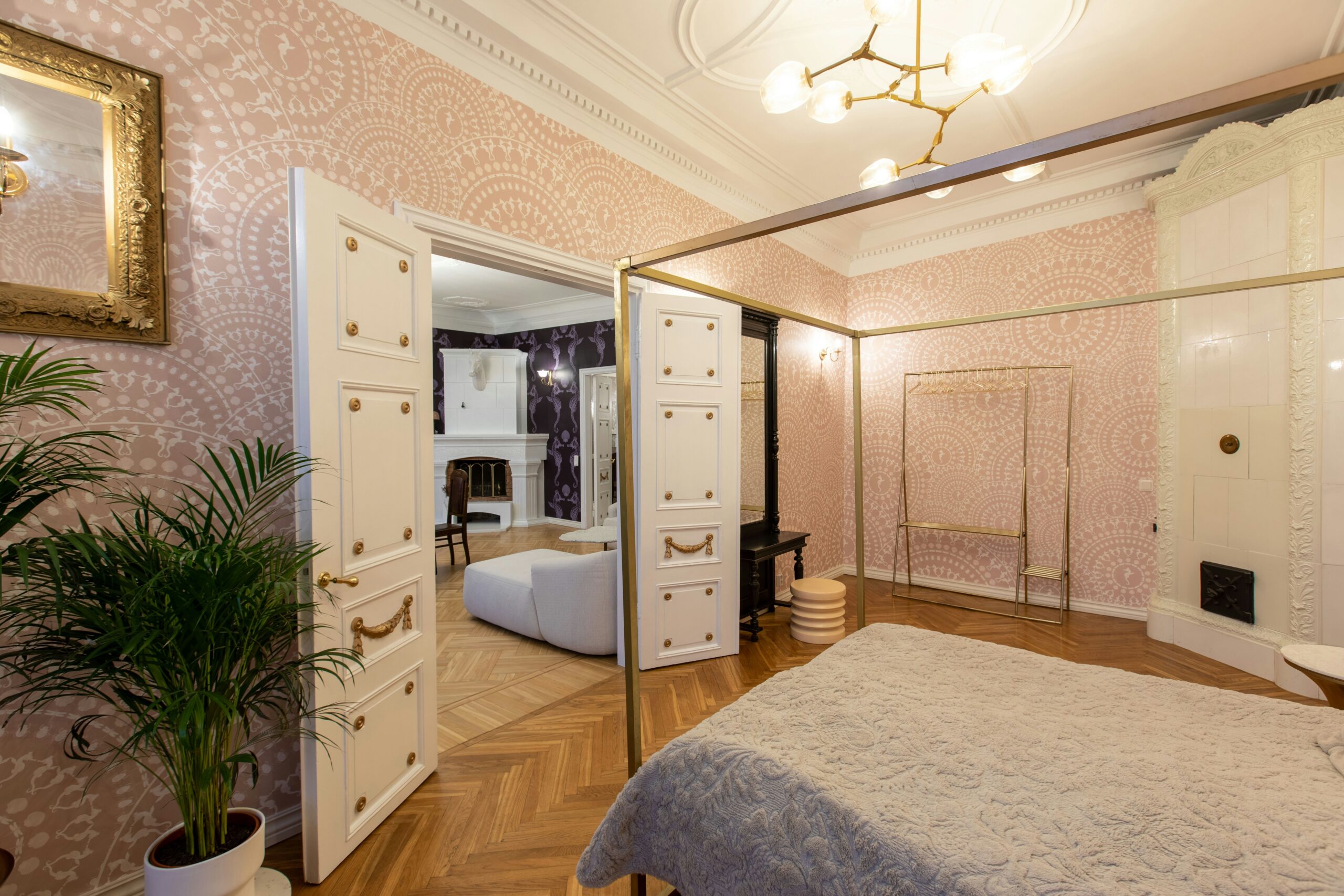 Luxurious bedroom in a historic home featuring a four-poster bed and antique dresser