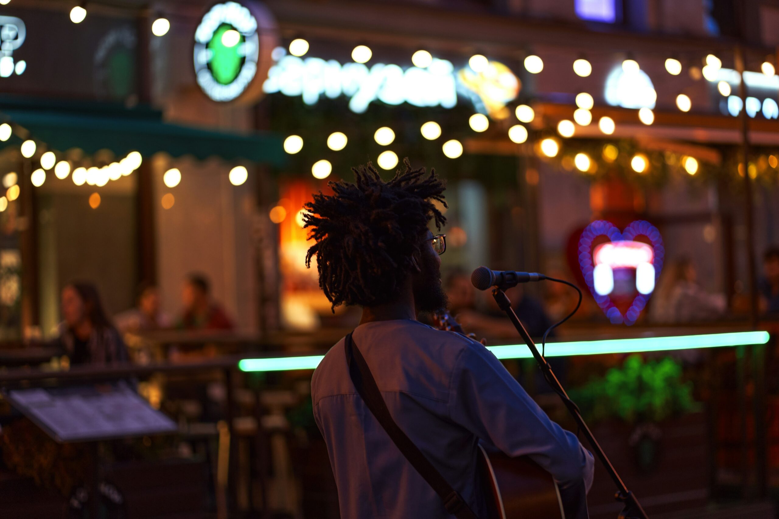 Sean-nós singer passionately performing in a dimly lit bar surrounded by locals