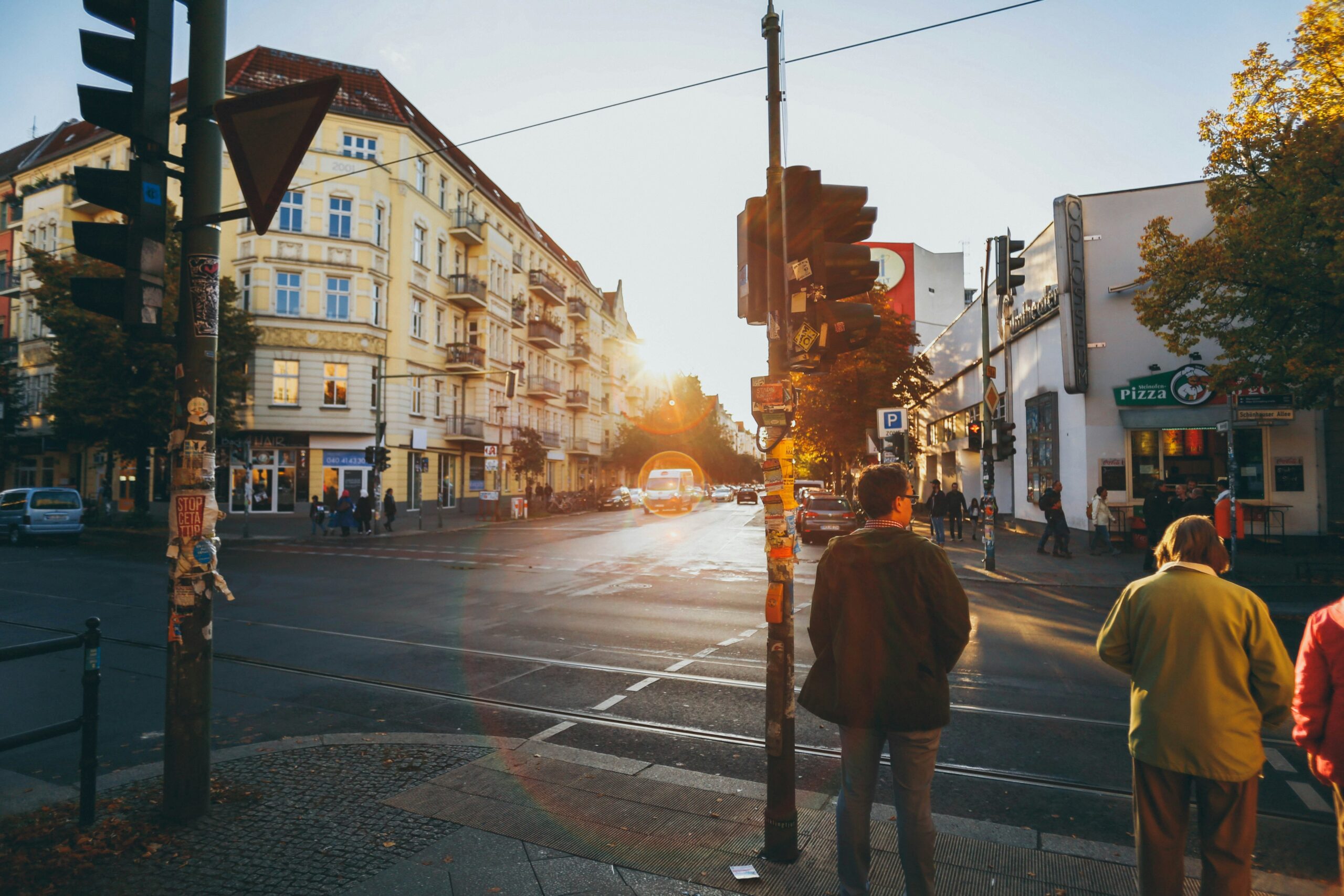 A cobblestone street winding through an old European town at sunset