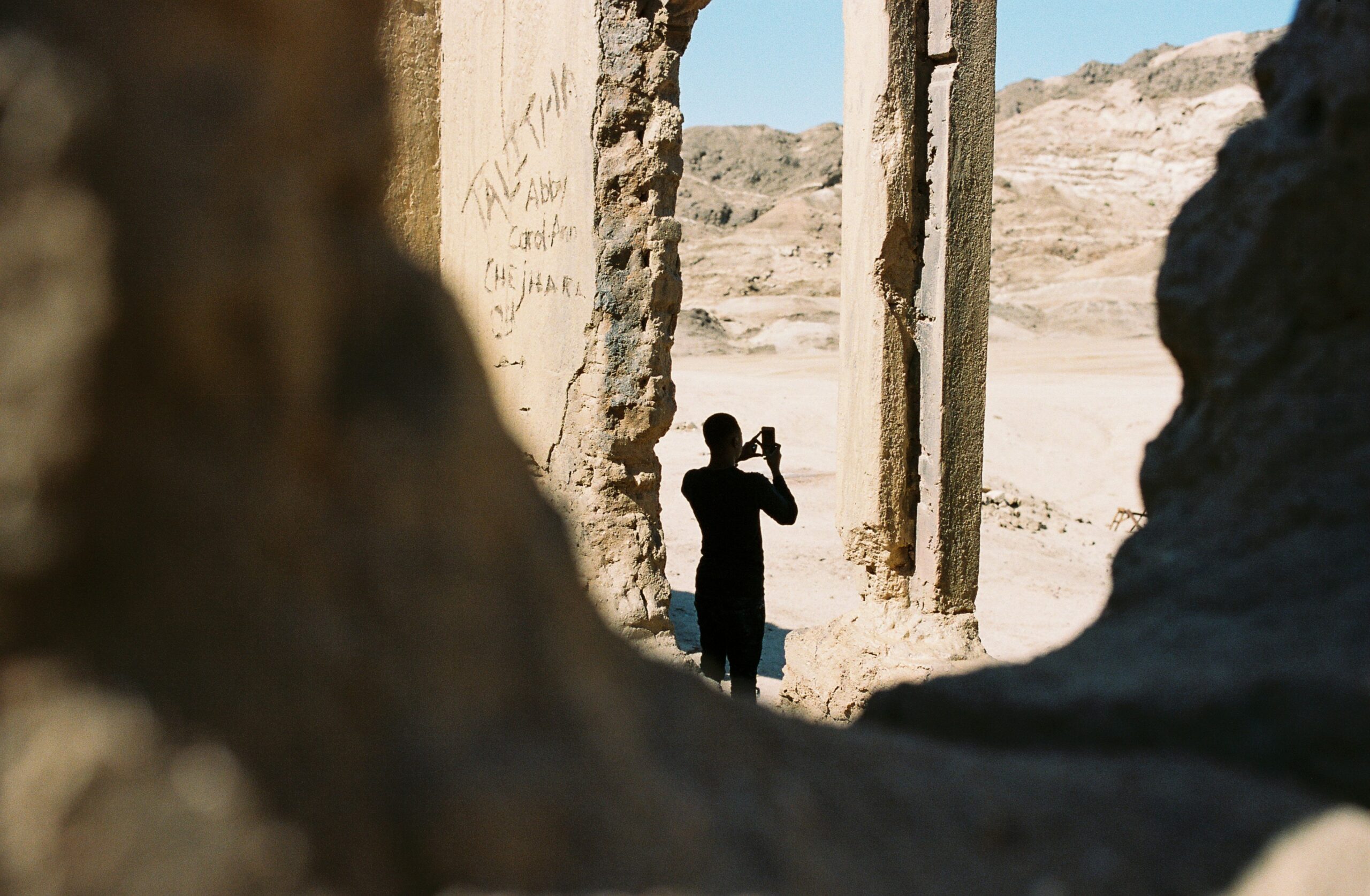A guide holding a flag leading a small group through historic ruins