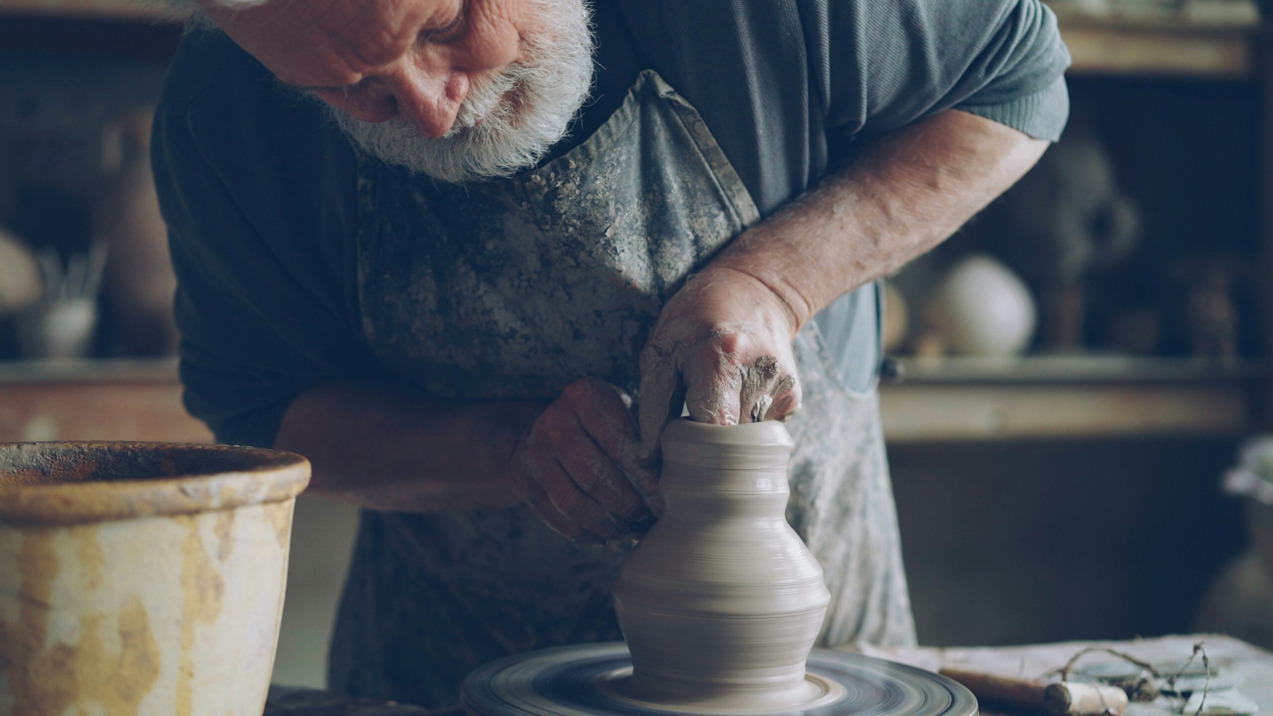 Sunlight streaming onto pottery wheel set against Italian countryside