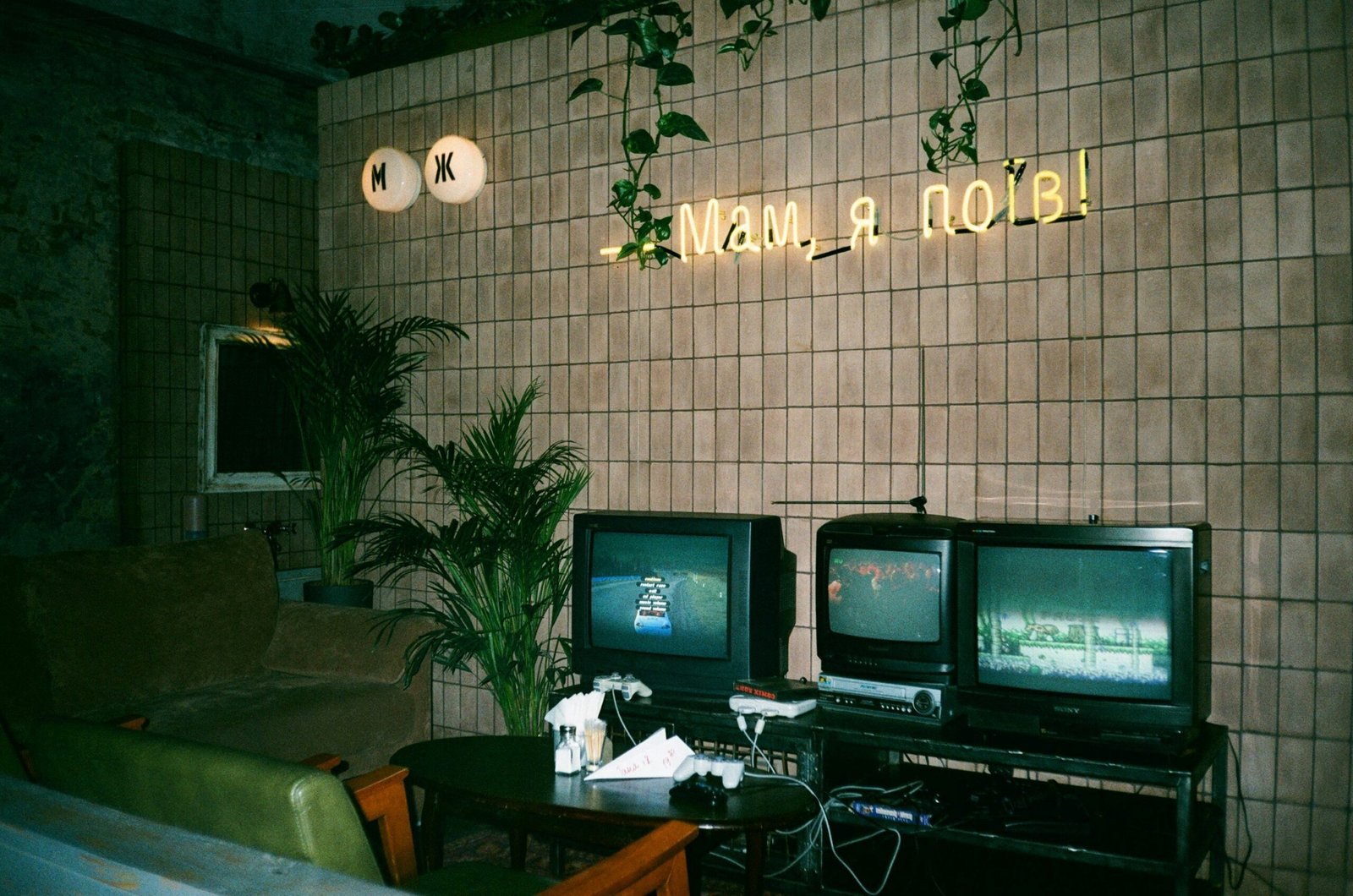 A cozy retro gaming room with an SNES console, bean bag chairs, and neon signs.