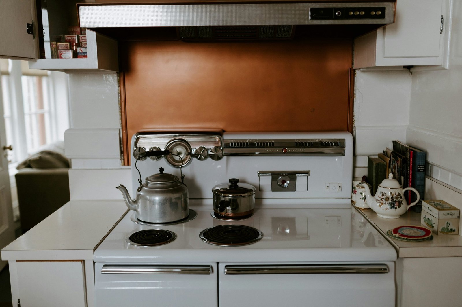 A vintage kitchen with retro appliances including a turquoise fridge and oven