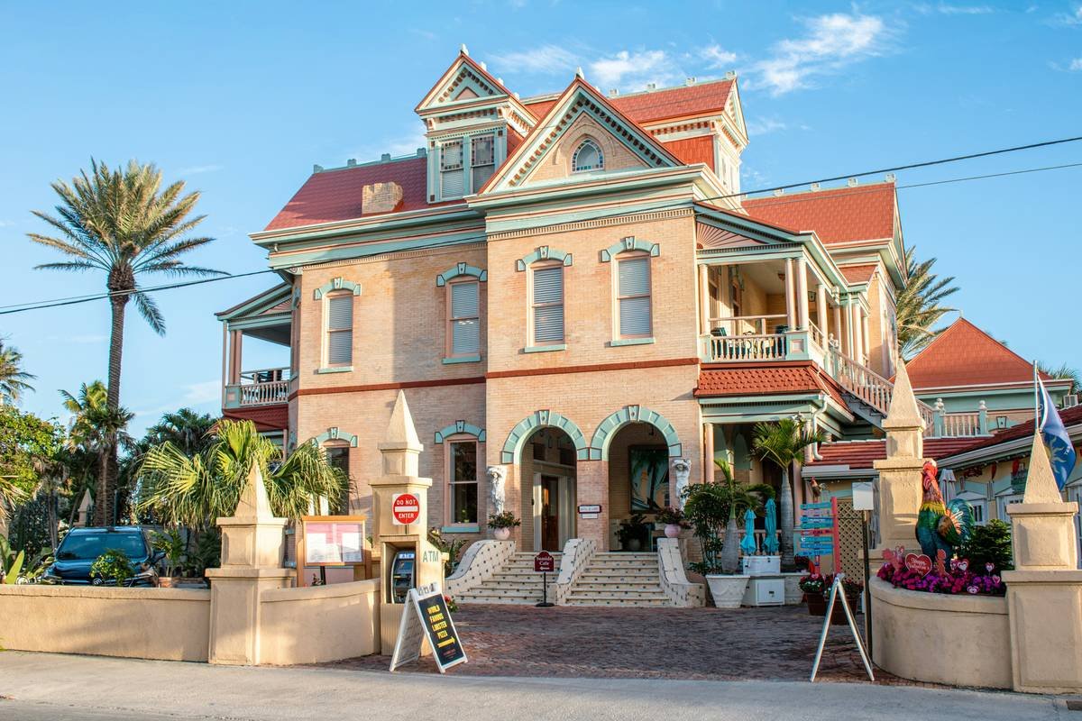 A beautifully restored 1920s living room with vintage furniture and a large screen projector setup