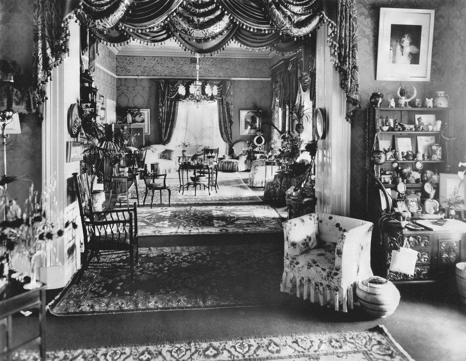 Large ornate Victorian armoire in a cozy bedroom setting.