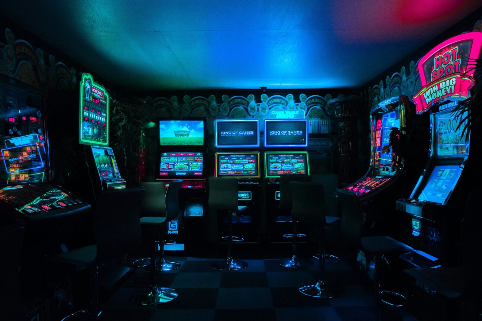 The interior of a historic home with arcade machines lined against the wall.