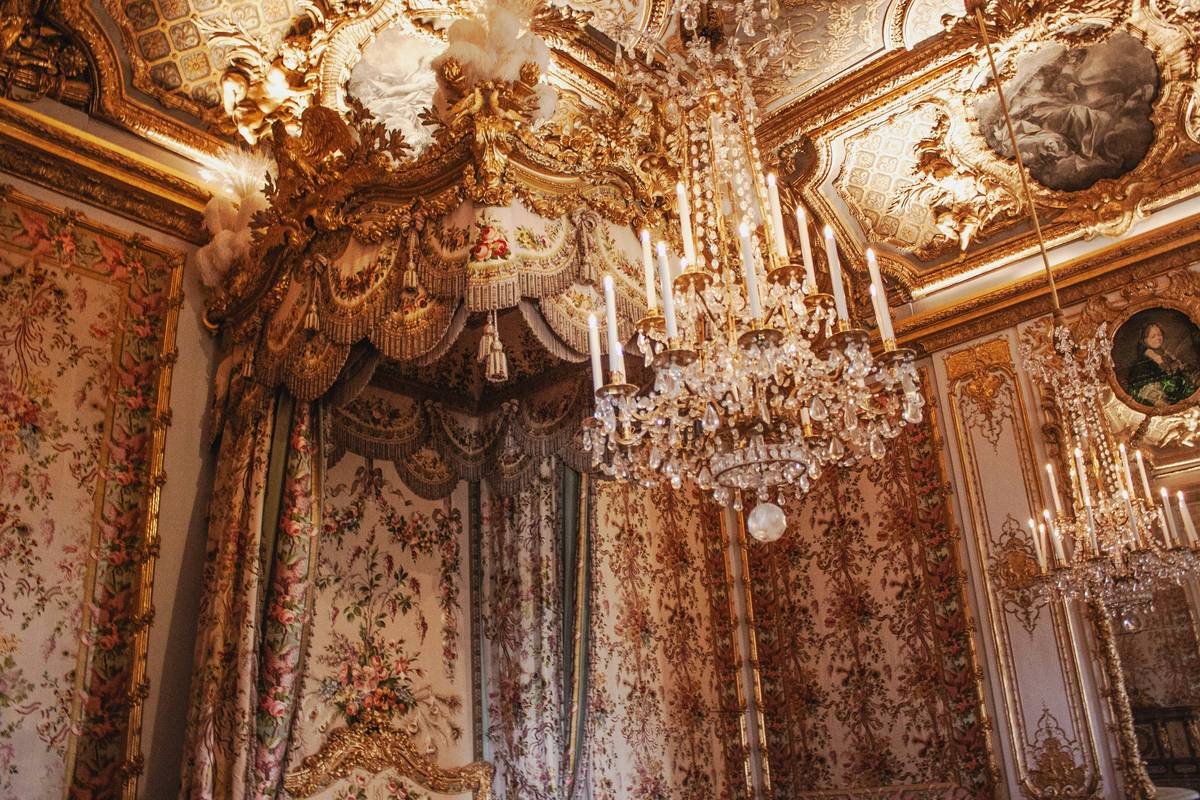 Exquisite interior of a vintage villa featuring grand chandeliers and antique furniture