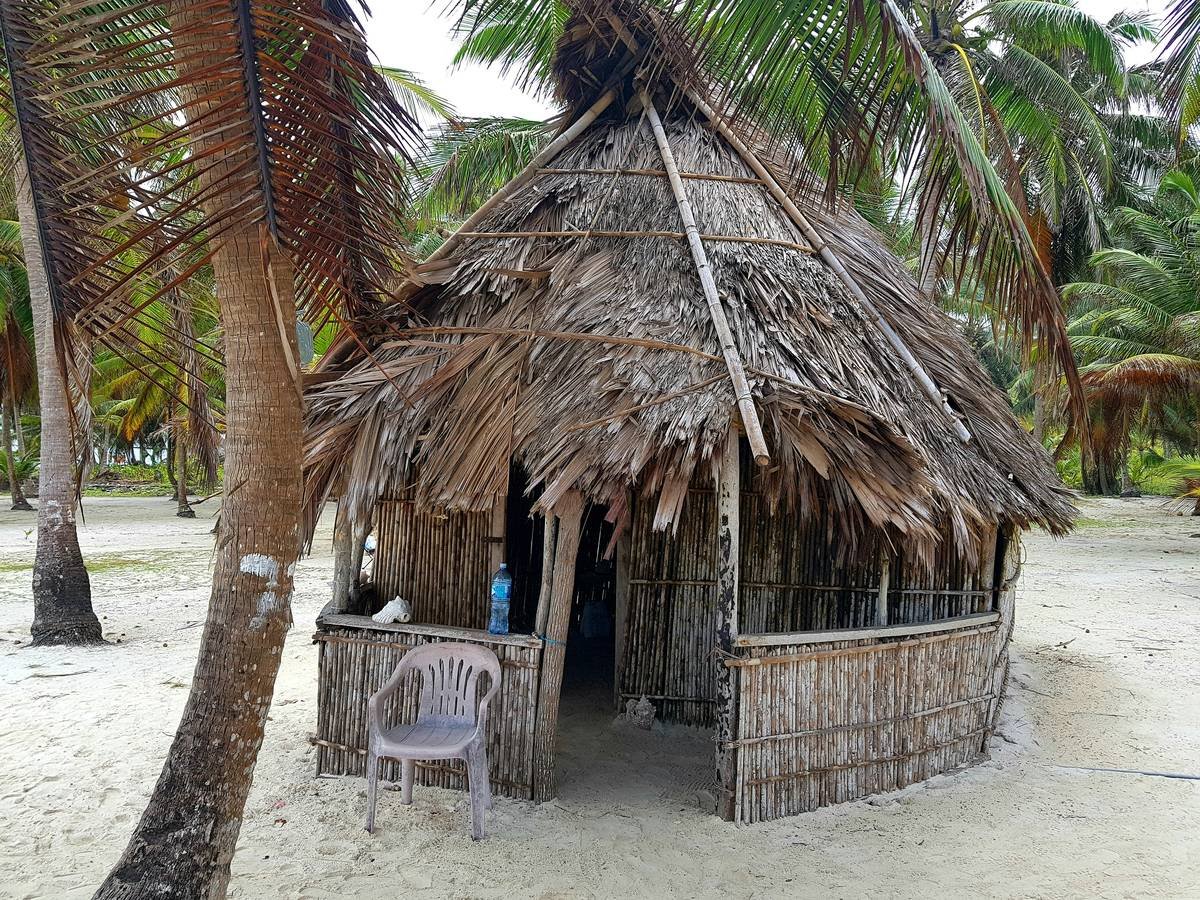 Interior shot showing original wooden beams and fireplace of a colonial villa