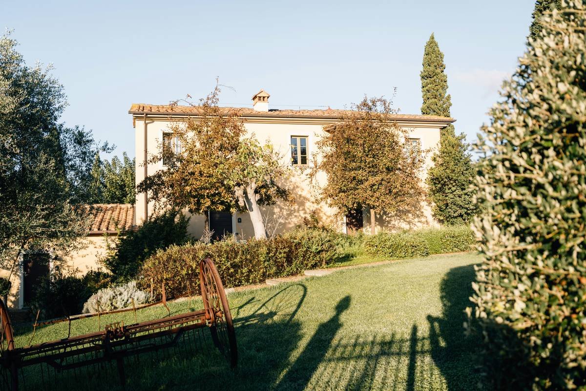 Sunset view of a French chateau surrounded by lush vineyards