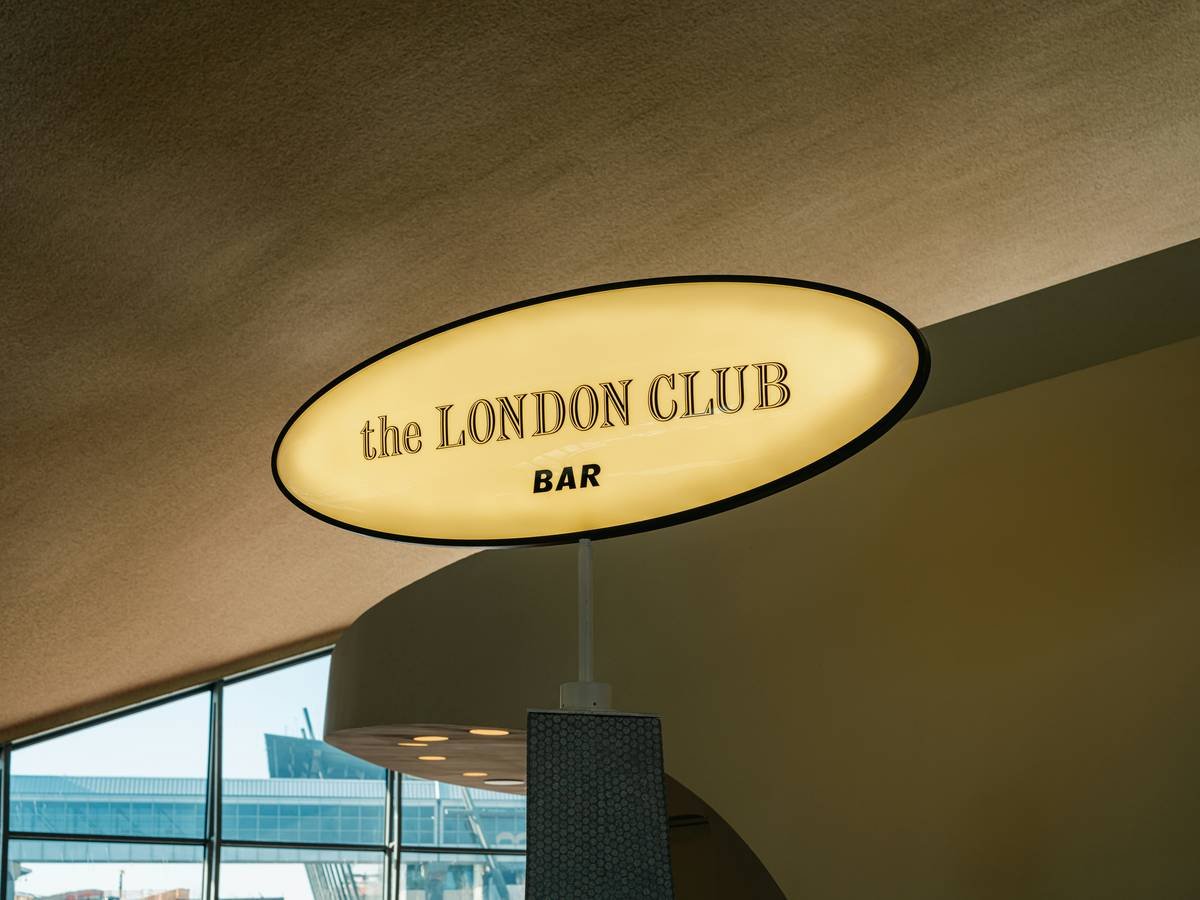 A charming stone cottage surrounded by lush greenery near a historic village