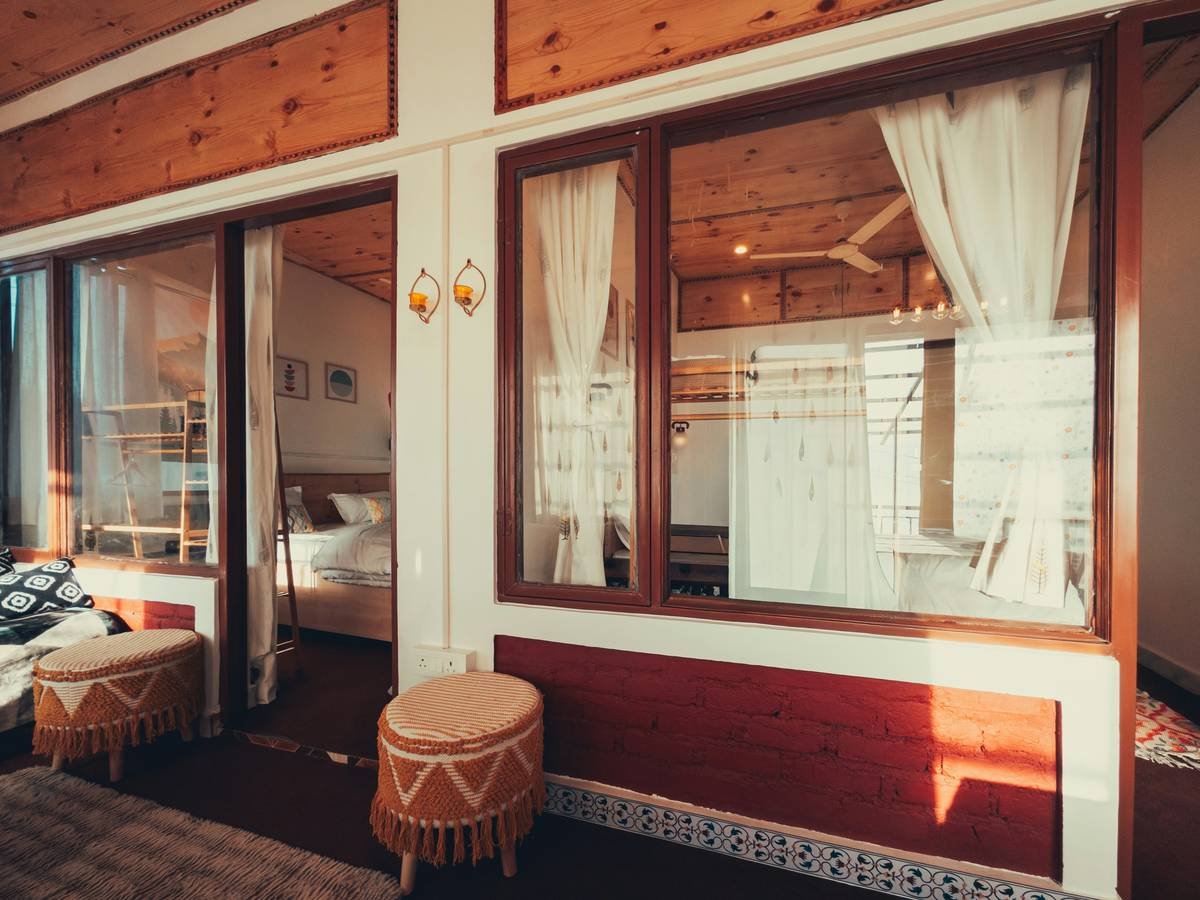 A cozy historic bedroom with stone walls and vintage furniture showcasing capsule old world stay charm.