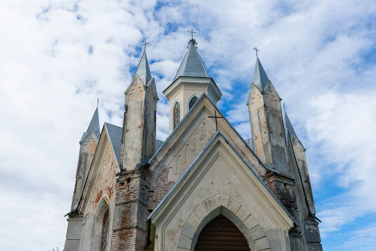 an old church with a steeple and a clock tower