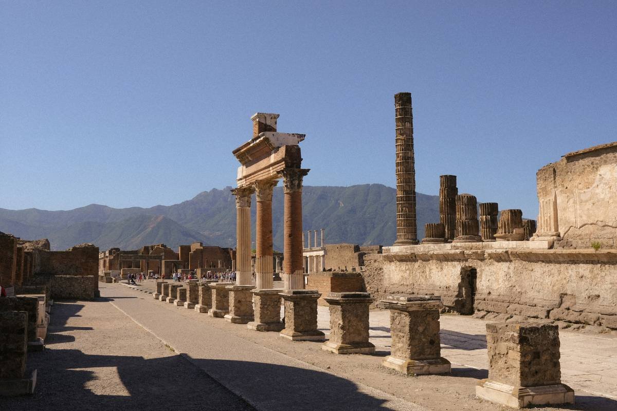 Ancient roman ruins with columns and mountains